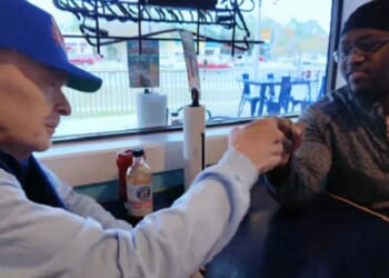 Longtime customer Charlie Hicks, left, fist bumps chef Donell Stallworth in a Shrimp Basket restaurant in Pensacola, Florida.