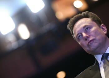 Elon Musk looks on as President Donald Trump speaks at the U.S.-Saudi Investment Forum at the John F. Kennedy Center for the Performing Arts in Washington, D.C., on Nov. 19, 2025.