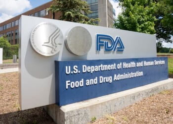 The FDA logo displayed on a sign outside the headquarters of the Food and Drug Administration of the Department of Health and Human Services (HHS).