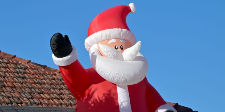 A large air inflatable Santa Claus Christmas outdoor decoration.