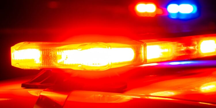 Police lights shine on top of first responder vehicles.