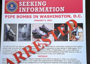 An FBI poster is displayed at the Department of Justice on Dec. 4 in Washington, D.C., during a press conference about the Jan. 6, 2021, pipe bomber case. Federal agents have charged Brian Cole with placing two pipe bombs, which never exploded, the night before the Jan. 6, 2021. U.S. Capitol incursion.