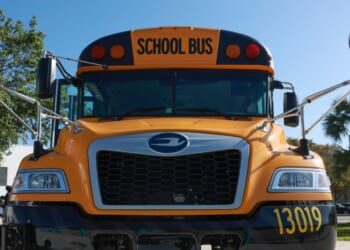 An electric bus is parked as Environmental Protection Agency Administrator Michael Regan visits during an event to highlight funding for electric school buses at the Coral Reef High School on March 11, 2024, in Richmond Heights, Florida.
