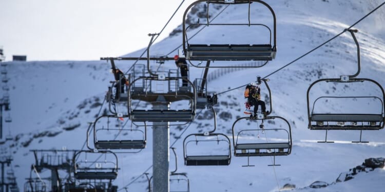 Ski lift operators practicing emergency response drills on a line of chairlift pylons at La Pierre Saint Martin in Arette, France, on Dec. 1, 2025.