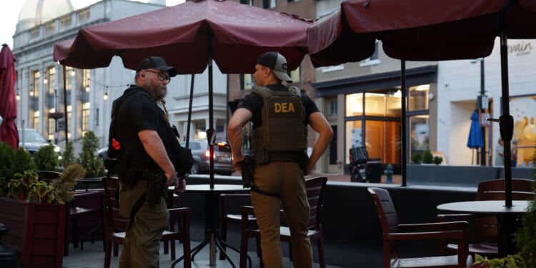 Drug Enforcement Administration personnel patrol M Street in Georgetown on Aug. 13, 2025, in Washington, D.C.