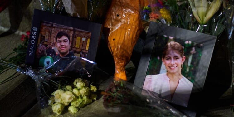 Framed photos of mass shooting victims Mukhammad Aziz Amurzokov and Ella Cook are seen Monday at a makeshift memorial near Brown University in Providence, Rhode Island.