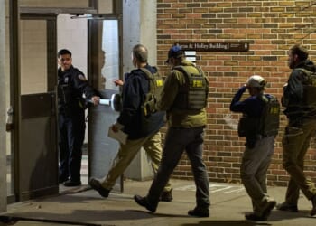 FBI agents enter the Barus and Holley building, home to the engineering and physics departments and the site of a mass shooting, at Brown University campus in Providence, Rhode Island, on Dec. 13, 2025.