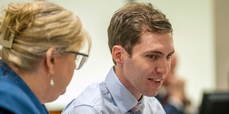 Tyler Robinson, the man accused of murdering conservative Charlie Kirk, shows a smile during a hearing in Provo, Utah, on Dec. 11, 2025.