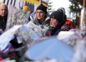 Sparkling candles atop wine bottles ignited fatal bar fire, Swiss investigators believe