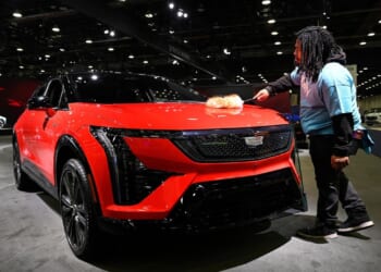 At Detroit auto show, spotlight dims for EVs