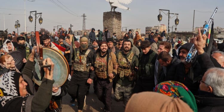 U.N. aid convoy delivering supplies to besieged city in northeast Syria as a shaky ceasefire holds