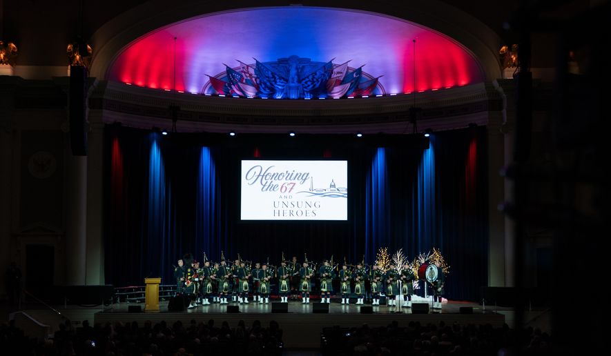 D.C. Fire Department Pipes and Drums perform at an event honoring the 67 lives lost in the 2025 midair collision near DCA airport, Wednesday, Jan. 26, 2026, in Washington. (AP Photo/Allison Robbert)