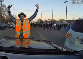 An anti-ICE protester stands in front of a police car in Memphis, Tennessee, on Jan. 11, 2026.