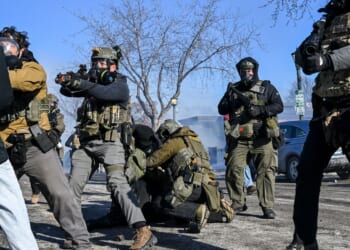 A person is tackled by federal agents as unrest escalates in Minneapolis, Minnesota, on Jan. 24, 2026.