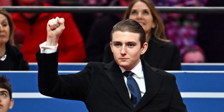 Barron Trump gestures after being acknowledged by his father, President Donald Trump, during the inaugural parade inside Capital One Arena, in Washington, D.C., on Jan. 20, 2025.