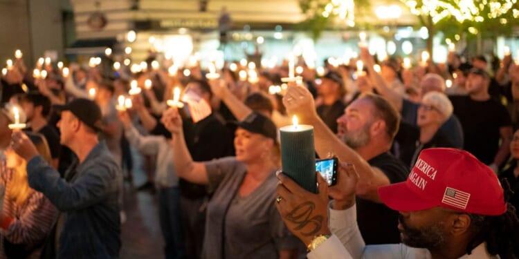 Attendees hold candles during a candlelight vigil and prayer event for Turning Point USA founder Charlie Kirk on Sept. 10, 2025, in Seattle, Washington.
