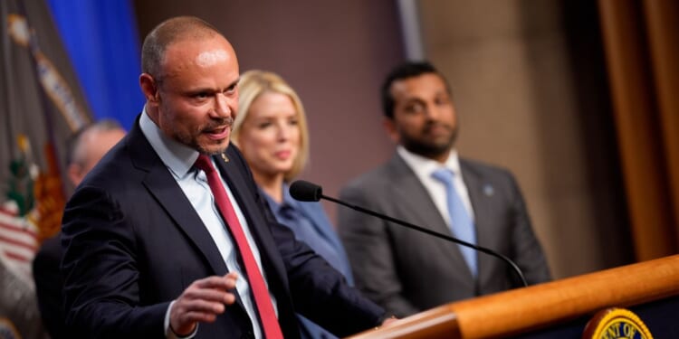 FBI Deputy Director Dan Bongino, accompanied by Attorney General Pam Bondi and FBI Director Kash Patel, speaks during a news conference on an arrest of a suspect in the pipe bomb case at the Department of Justice on Dec. 4, 2025, in Washington, D.C.