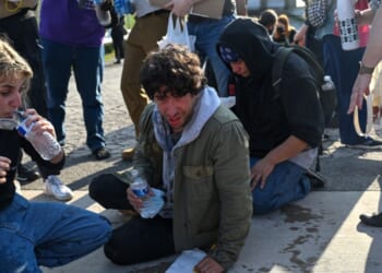 Demonstrators protesting outside a U.S Immigration and Customs Enforcement facility, including Democratic congressional candidate Kat Abughazaleh, left, react after being tear-gassed on Sept. 19, 2025, in Broadview, Illinois.