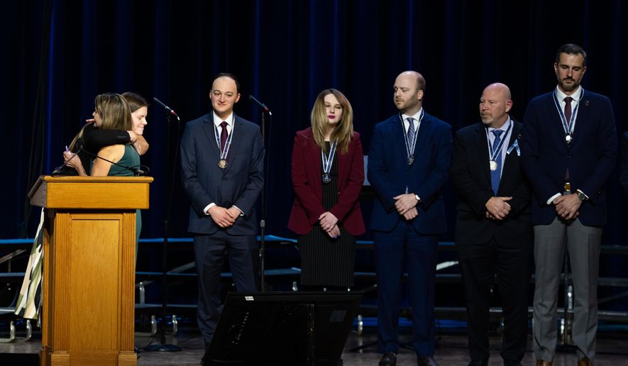 First responders accept medals at an event honoring the 67 lives lost in the 2025 midair collision near DCA airport, Wednesday, Jan. 28, 2026, in Washington. (AP Photo/Allison Robbert)