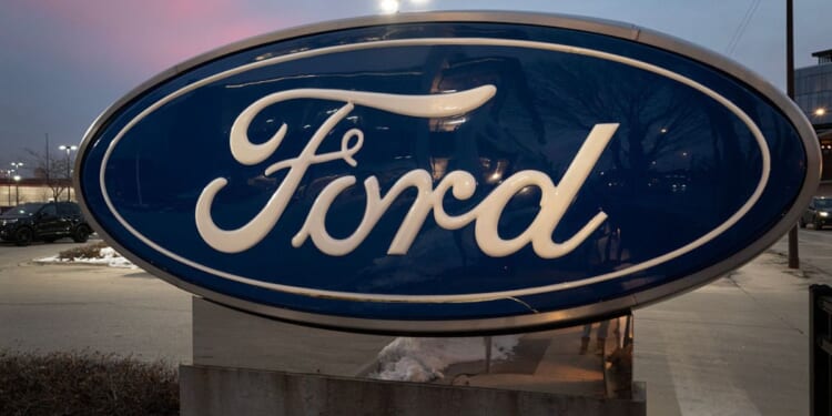 A sign with the Ford logo sits in front of a Chicago dealership in a file photo dated Dec. 15.