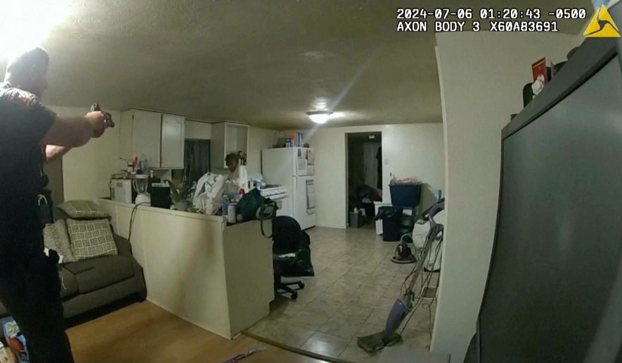 In this image taken from body camera video released by Illinois State Police on Monday, July 22, 2024, former Sangamon County Sheriff's Deputy Sean Grayson, left, points his gun at Sonya Massey, who called 911 for help, before shooting and killing her inside her home in Springfield, Ill., July 6, 2024. (Illinois State Police via AP, File)