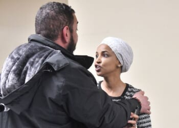 Rep. Ilhan Omar reacts after being sprayed with an unknown substance by a man as she hosted a town hall in Minneapolis, Minnesota, on Jan. 27, 2026.