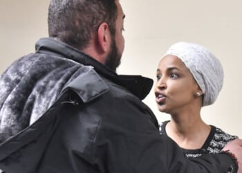 US Rep. Ilhan Omar reacts after being sprayed with an unknown substance by a man at a town hall in Minneapolis, Minnesota, on Jan. 27, 2026.
