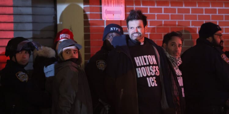 NYPD officers arrest immigration rights activists after a sit-in at the Hilton Garden Inn on Jan. 27, 2026, in New York City.