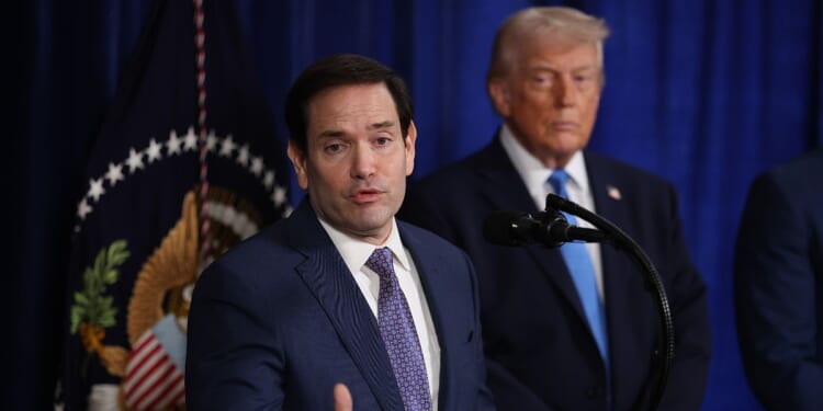 Secretary of State Marco Rubio speaks during a press conference as President Donald Trump listens at Mar-a-Lago club on Jan. 3, 2026, in Palm Beach, Florida.