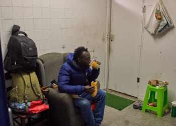Yankuba Touray, from Gambia, eats his breakfast inside an abandoned school in Badalona, near Barcelona, Spain, on Dec. 16, 2025.