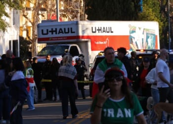 People walk near a U-Haul truck that reportedly was driven into a crowd during an anti-Iranian regime rally on Jan. 11, 2026, in Los Angeles, California.