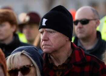 Minnesota Gov. Tim Walz and his wife Gwen Walz look on during a vigil for Renee Good on the steps of the state capitol building on Jan. 9, 2026, in St. Paul, Minnesota.