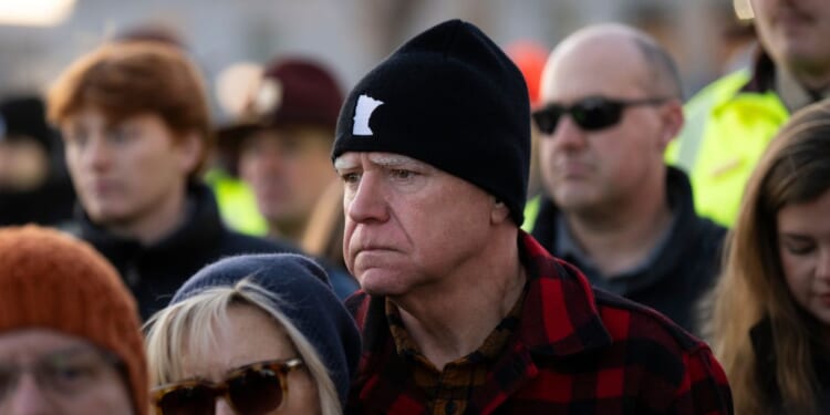 Minnesota Gov. Tim Walz and his wife Gwen Walz look on during a vigil for Renee Good on the steps of the state capitol building on Jan. 9, 2026, in St. Paul, Minnesota.