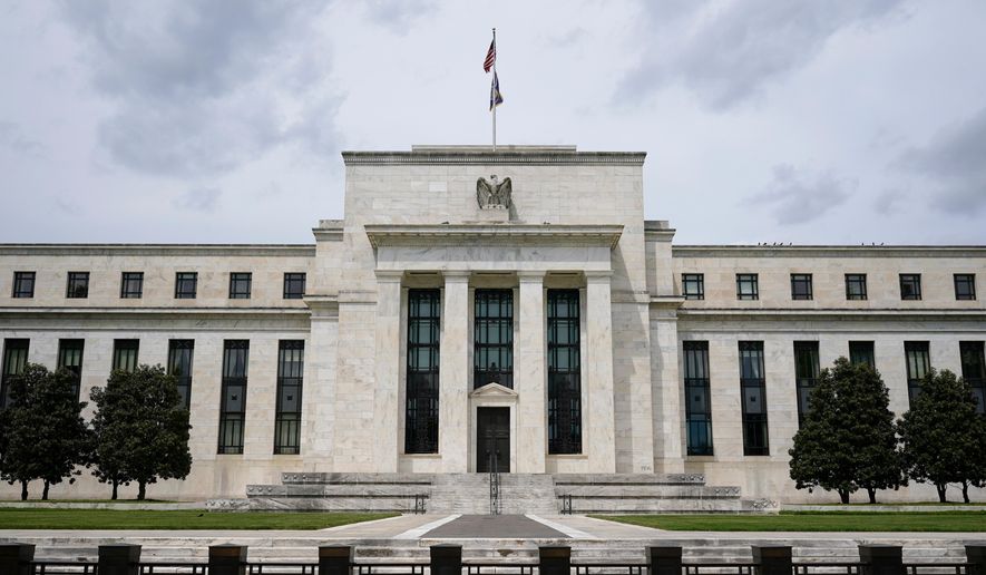 A U.S. flag flies over the Federal Reserve building on May 4, 2021, in Washington. (AP Photo/Patrick Semansky, File)