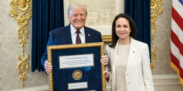 President Donald Trump accepts a Nobel Peace Prize originally awarded to Venezuelan opposition leader Maria Corina Machado who chose to gift it to him in the Oval Office of the White House on Jan. 15, 2026 in Washington, DC.