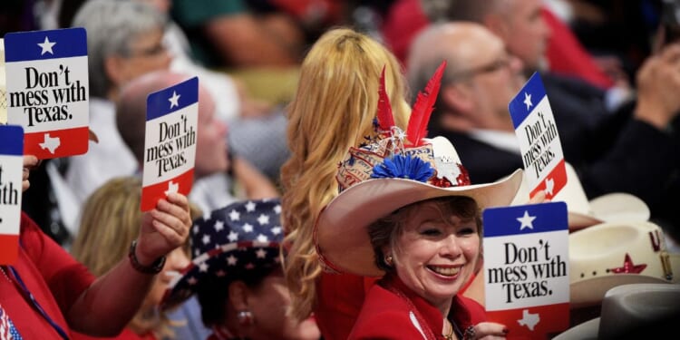 Delegates from Texas hold signs that read "Don't Mess with Texas" on the second day of the Republican National Convention on July 19, 2016, at the Quicken Loans Arena in Cleveland, Ohio.