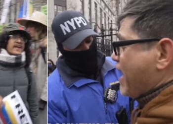 A Venezuelan, right, confronts pro-Maduro protesters, left, as New York Police Department officers try to separate the two groups.