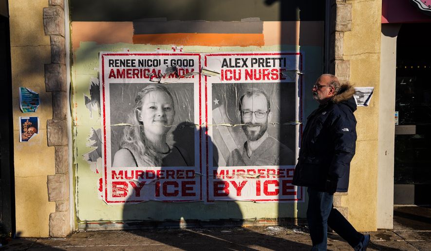 A man walks by posters of Renee Nicole Good and Alex Pretti, who were both fatally shot by federal agents, in Minneapolis, Saturday, Jan. 31, 2026. (AP Photo/Ryan Murphy)