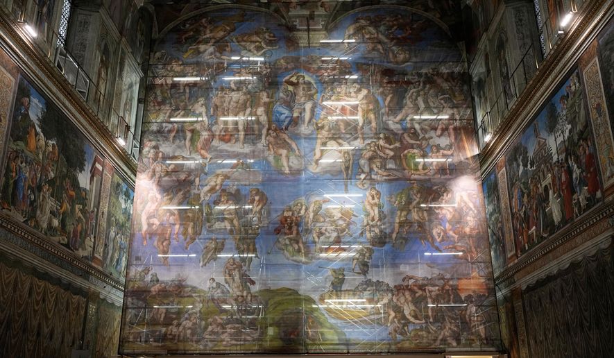 A screen with a replica of “The Last Judgment,” superimposed on it covers the scaffolding used for its extraordinary maintenance during a presentation for press in the Sistine Chapel at the Vatican, Saturday, Feb. 28, 2026. (AP Photo/Alessandra Tarantino)