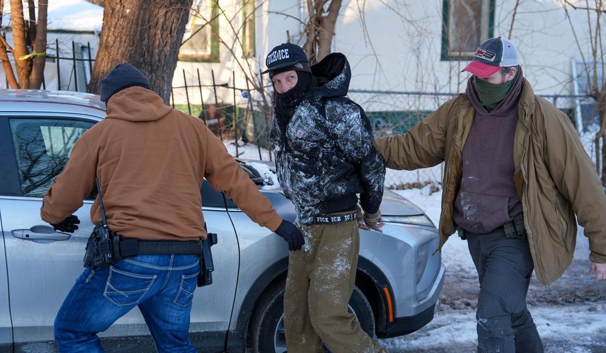 An activist is detained by federal agents on Tuesday, Feb. 3, 2026, in Minneapolis. (AP Photo/Ryan Murphy)