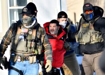 Federal immigration agents detain a man during an ICE and border patrol operation in St. Paul, Minnesota, on Jan. 27, 2026.