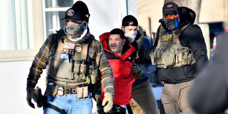 Federal immigration agents detain a man during an ICE and border patrol operation in St. Paul, Minnesota, on Jan. 27, 2026.