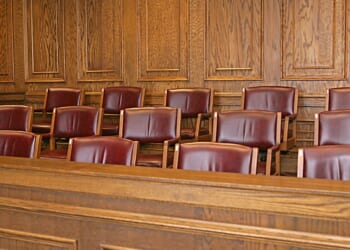 A jury box sits in a courthouse's courtroom.