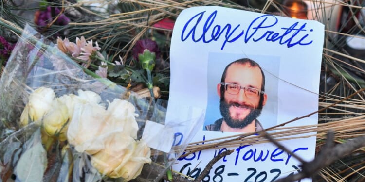 Flowers are left at a makeshift memorial in the area where Alex Pretti was shot dead a day earlier by federal immigration agents in Minneapolis, Minnesota, on Jan. 25, 2026.