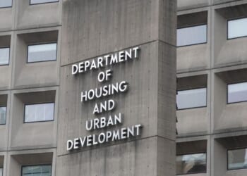 A view of the U.S. Department of Housing and Urban Development from the outside with the department's name displayed on the side of the building.