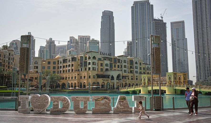 A few people walk in a public plaza in downtown Dubai, United Arab Emirates, Tuesday, March 3, 2026. (AP Photo/ Fatima Shbair)