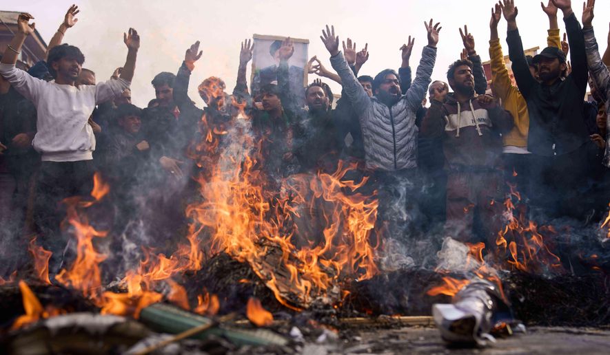 Shiite Muslims shout slogans as they burn effigies of President Donald Trump and Israeli Prime Minister Benjamin Netanyahu during a protest against the killing of Iran's Supreme Leader Ayatollah Ali Khamenei, in Budgam, northeast of Srinagar, Indian controlled Kashmir, Friday, March 6, 2026. (AP Photo/Dar Yasin)