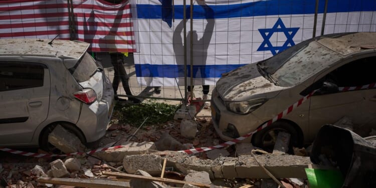 Israel says it’s killed another top Iranian official while Iran’s attacks slay 2 near Tel Aviv