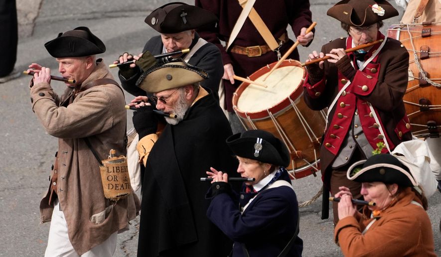 Members of a fife and drum band march in a procession during an Evacuation Day ceremony marking the 1776 departure of British troops from the city during the American Revolutionary War, Tuesday, March 17, 2026, in Boston. (AP Photo/Robert F. Bukaty)