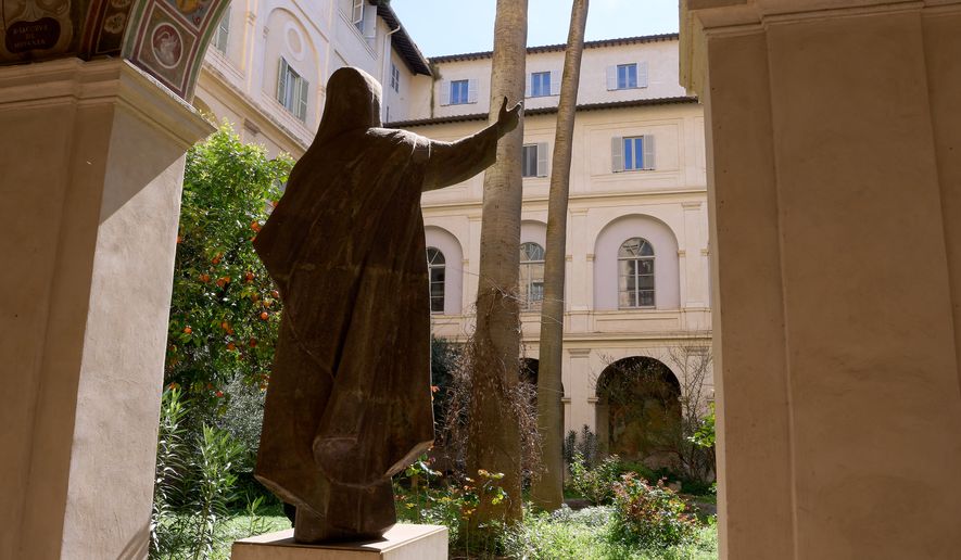 A cat sidles away as journalists visit the cloister of the Basilica of Santa Maria sopra Minerva in Rome, Wednesday, March 18, 2026. (AP Photo/Domenico Stinellis)